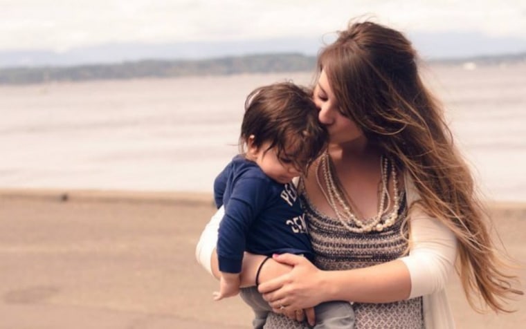 Danielle Campoamor on beach with child