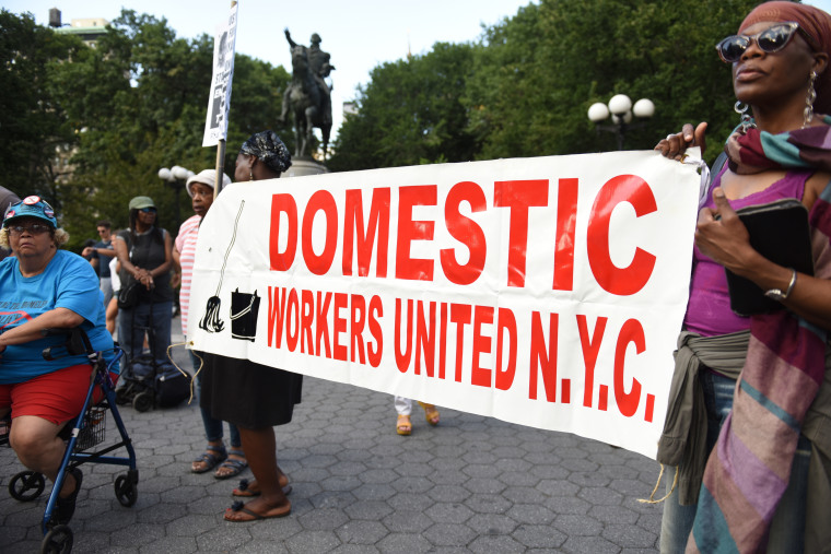 Domestic Workers United with a banner at Union Square rally