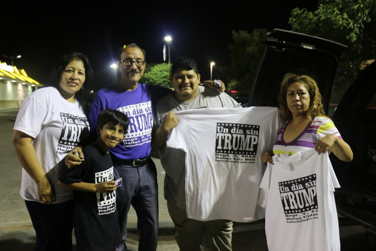 Carlos Quintanilla, 57, in purple, gathers with a group of volunteers who helped him plan an Anti-Trump rally in Dallas, Sunday, Sept. 6, 2015. Quintanilla said he was able to do it with the help of a small committee of seven, and nearly 60 volunteers who helped him spread the word on the streets and through social media.