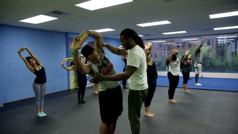 Sultan Malik helps a student in class.