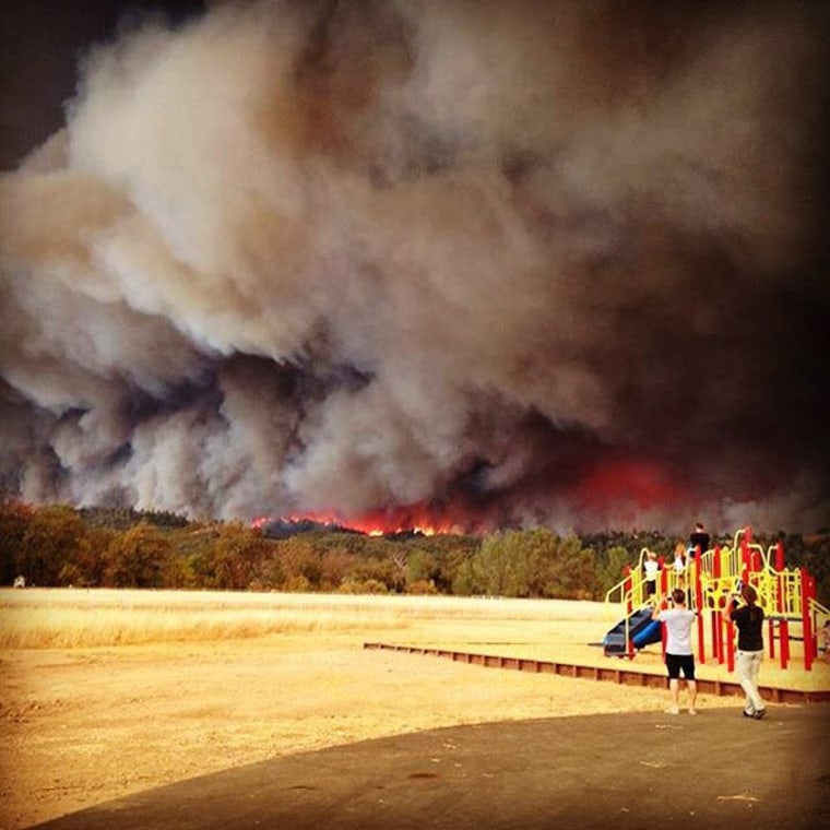 Flames and smoke from the fast-moving Valley Fire is seen from Middletown, California, Saturday, Sept. 12.