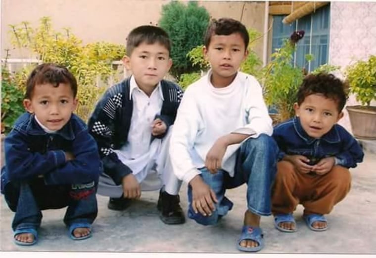 Ali Hassanzadeh is seen here in white when was just 11 years old. This is one of the only pictures he has with him to remind him of home. His two brothers are the boys on the ends. Hasan, then aged 8, and Hameed, then aged 7.