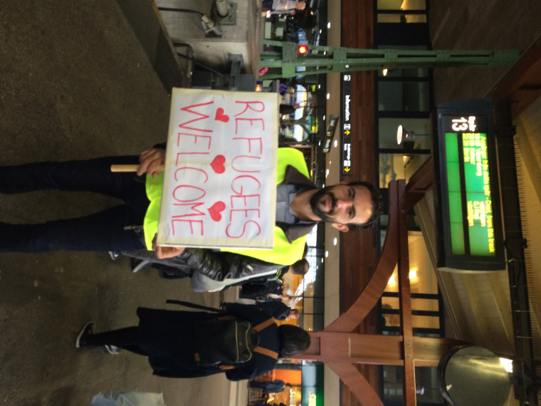 Image: Residents welcome refugees on train platform in Gutenberg, Sweden