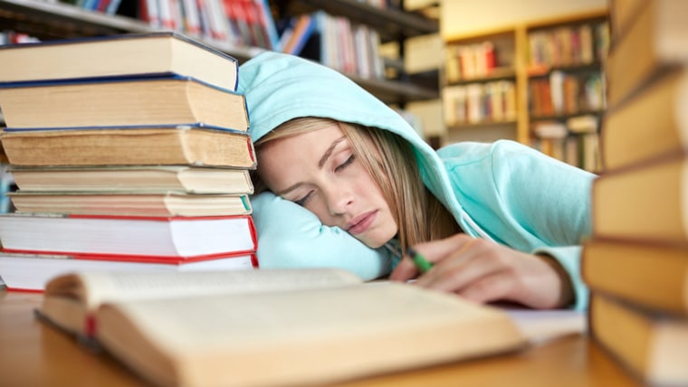 people, education, session, exams and school concept - tired student girl or young woman with books sleeping in library; Shutterstock ID 292918232; PO: Brandon for trending