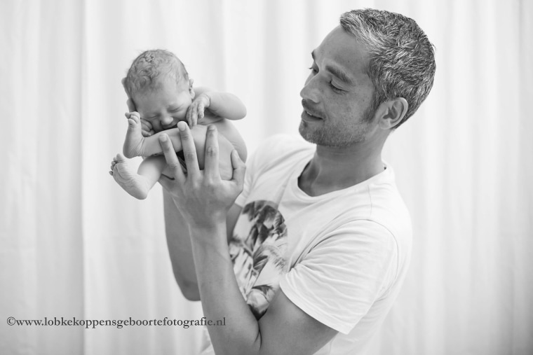 Marry Fermont's boyfriend Denny holds their newborn daughter.
