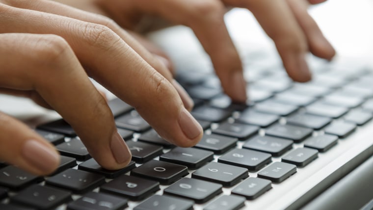 Female hands typing on laptop