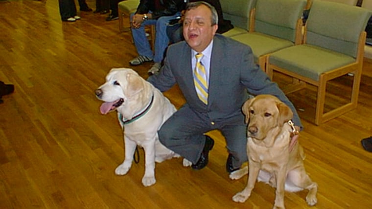 Omar Rivera with guide dogs Salty and Montana