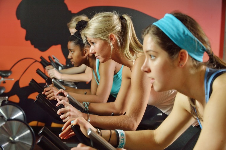 Students participate in a spin class at Virginia Tech's McComas Hall.