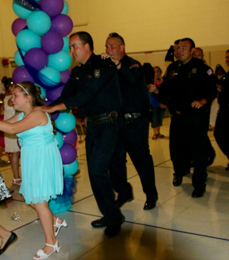 Jewel Warren attended a father-daughter dance with 6 police officers