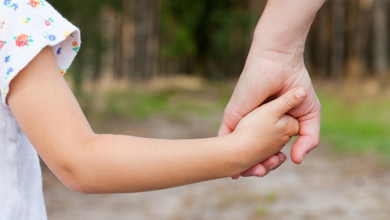 Parent and child holding hands