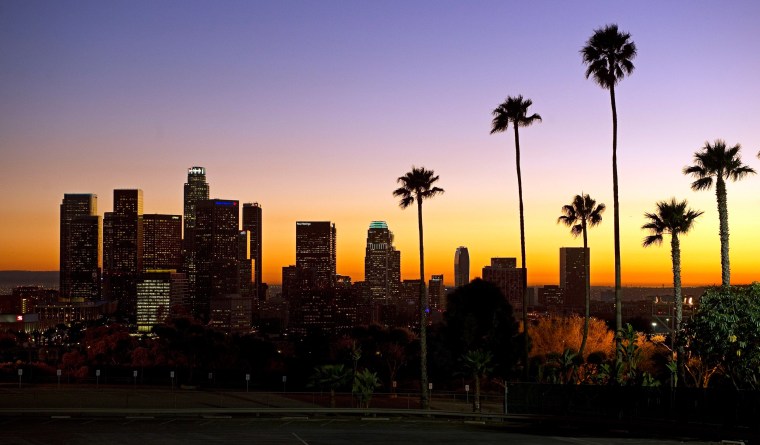 Image: The sun sets beyond the Los Angeles skyline