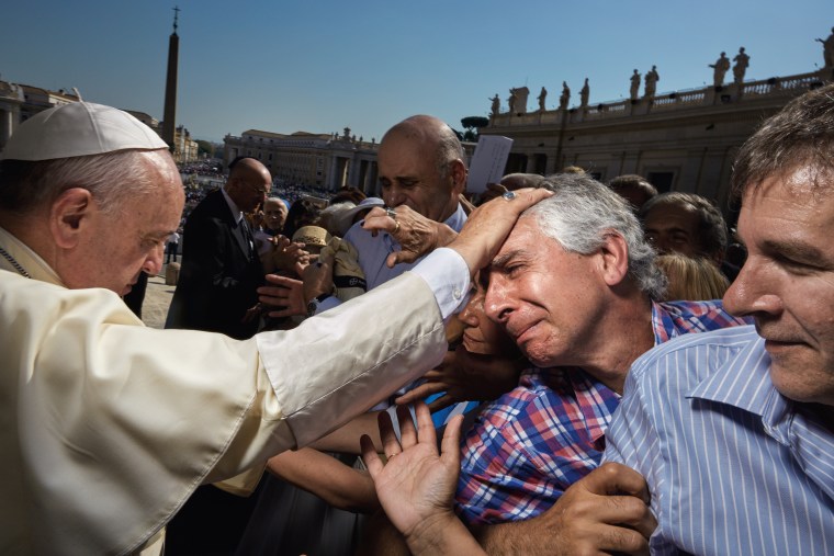 The power of faith brims over for parishioners in St. Peter’s Square as Pope Francis extends his touch. 
