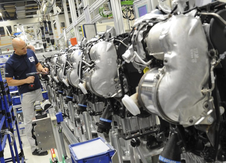 Image: VVolkswagen employee works on a diesel engine