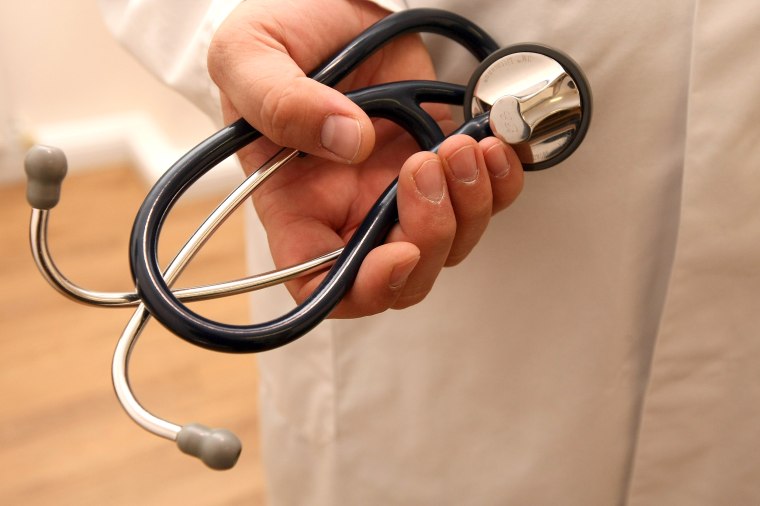 Image: A doctor holds a stethoscope