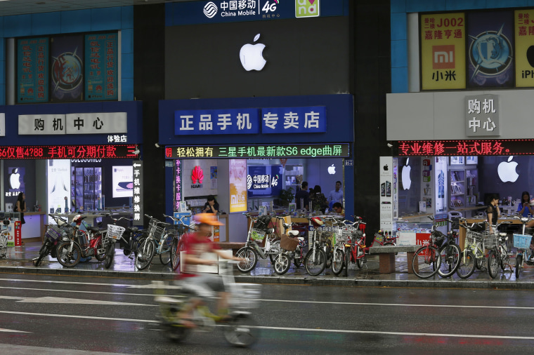 Image: Apple logos are seen in stores in Shenzhen