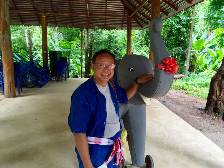 Prasop Tipprasert, the founder of the program, with a model elephant he uses to first teach kids how to ride.