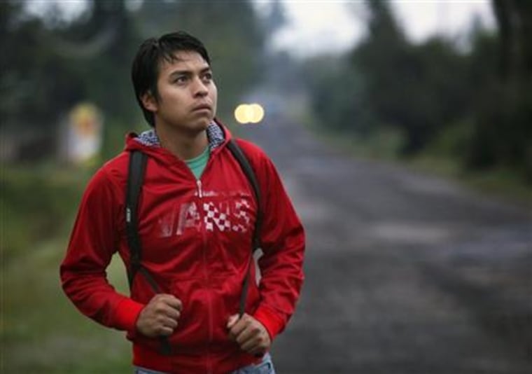 In this Sept. 15, 2015 photo, Lenin Mondragon, the brother of slain college student Julio Cesar Mondragon, walks in San Miguel Tecomatlan, a rural town in the hills of Mexico state. Lenin's brother was killed one year ago on Sept. 26, 2014 in Iguala during an attack that left 43 students disappeared. The family gathers most Saturdays at the large table in their uncle Cuitlahuac’s modest concrete home, sometimes to meet with their lawyer, sometimes for psychological counseling, and always to plot a path to justice. "Here we all pretend to be strong," said Lenin, who has his brother’s eyes, now always filled with sadness.