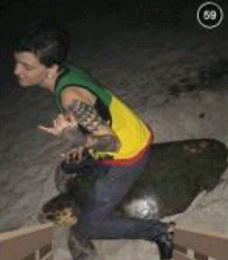 Police in Florida released this photo that appears to show a woman sitting or riding on a sea turtle.