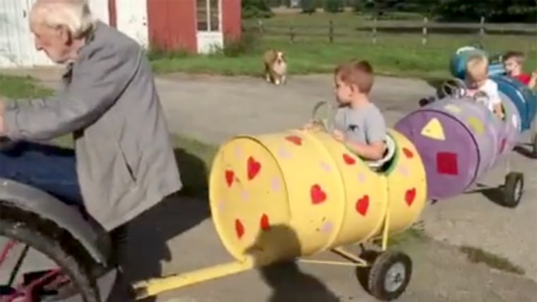 Alvin Bogie takes his great-grandsons for a spin on his 1919 tractor and the train he made to haul kids.