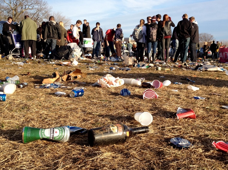 Bottles of alcohol litter a parker lot outside the Yale Bowl after an NCAA college football game between Yale and Harvard at Yale Bowl, Saturday, Nov. 23, 2013 in New Haven, Conn.