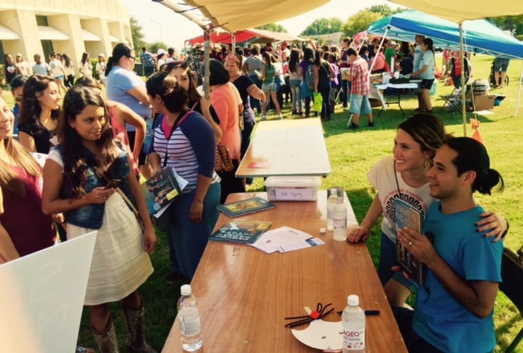 Children's book author and the 2015 Tomás Rivera Mexican American Children’s Book Award winner Duncan Tonatiuh poses with a fan during his autograph session at the Tomás Rivera Mexican American Children’s Book Award Literature Fair in San Marcos, Texas.