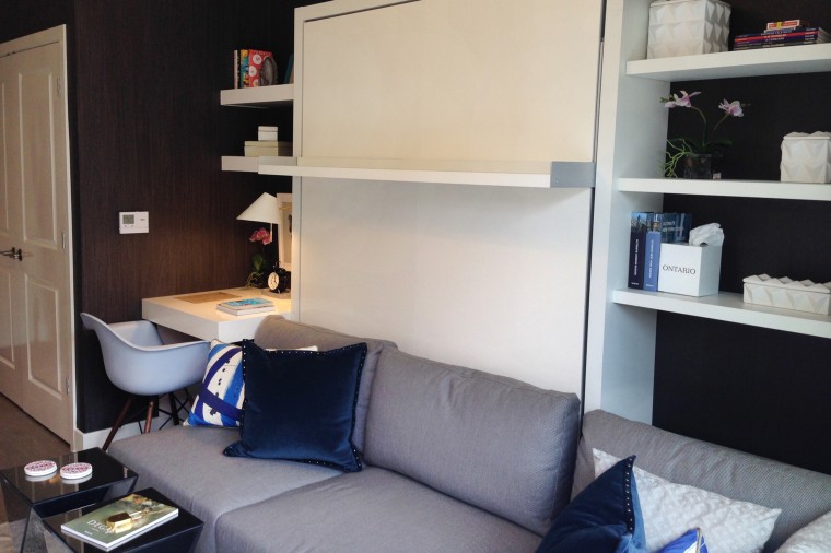 Studio model unit has Murphy-style bed wall unit to maximize 372 square feet.