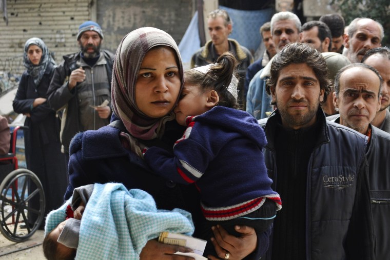 Image: Residents of the Yarmouk refugee camp in Damascus, Syria