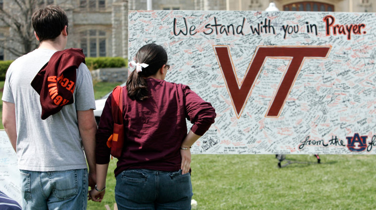 Image: Students visit a makeshift memorial