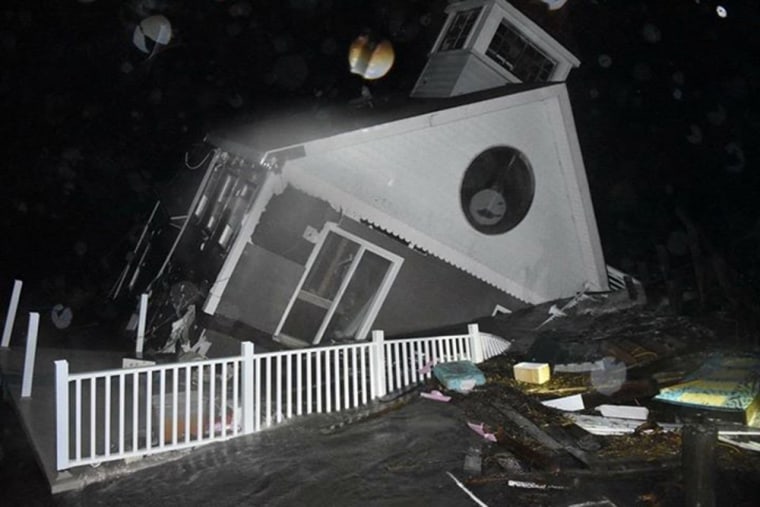 A house collapses into the bay in Wildwood, New Jersey, early on Oct. 3