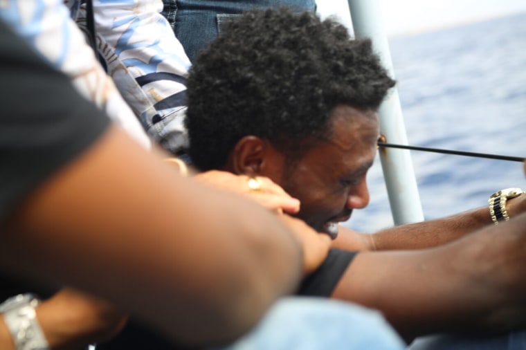 Image: An Eritrean migrant who survived a shipwreck off the coast of the Italian island of Lampedusa is overcome with emotion