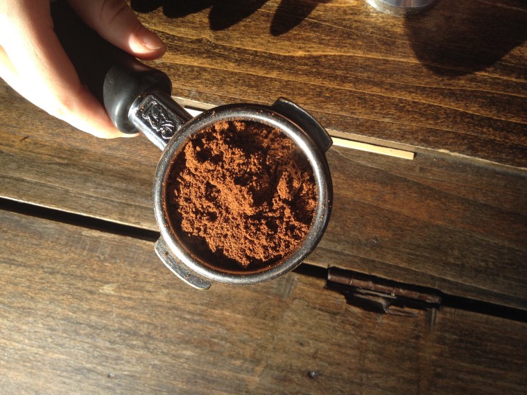 Grind coffee beans into a fine powder to make espresso