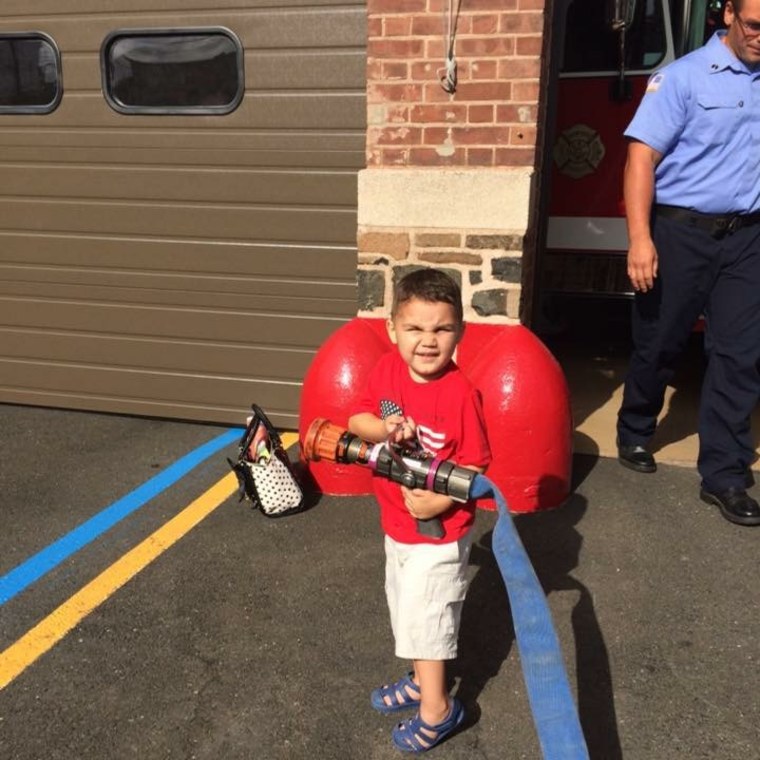 Give the kid a fire hose and he's all smiles.