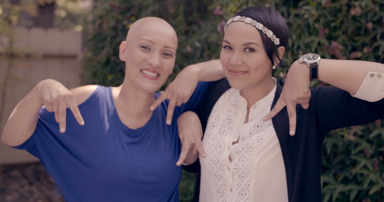 Rachel, left, and Abby met through a Facebook group. Here they're making the alopecia awareness sign.