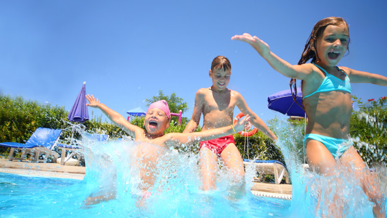 Kids jumping into the swimming pool