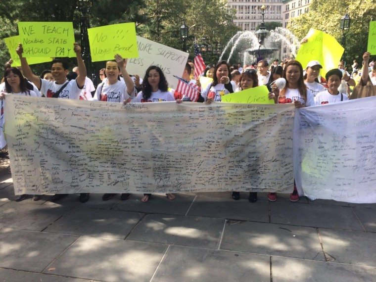 Chinese-American nail salon owners and workers assemble at nearby City Hall Park in New York City to protest enforcement of the state’s nail salon legislation, signed into law in July.