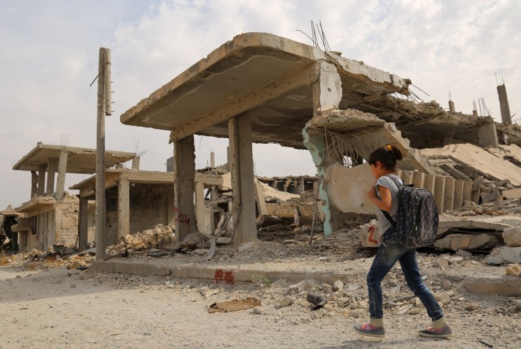 Image: A girl heads to school in Kobani, Syria, on Oct. 6