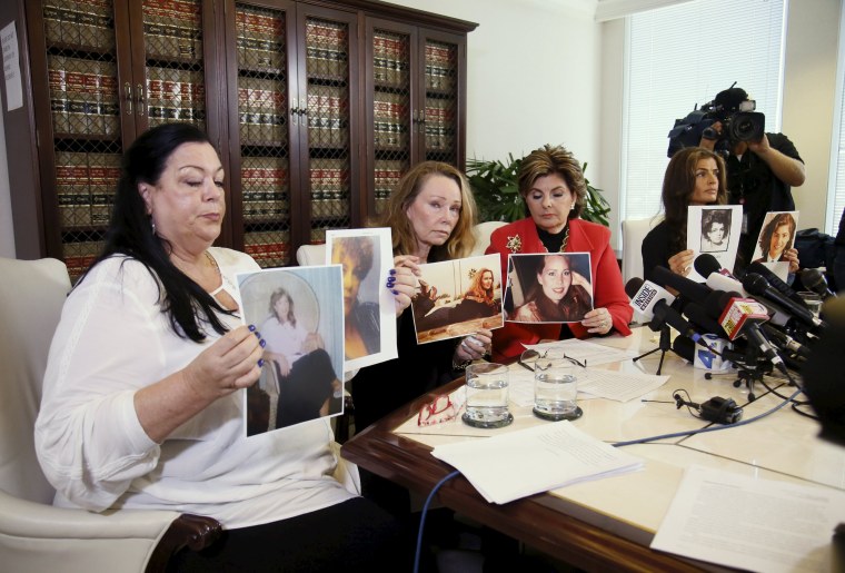 Image: Pamela Abeyta, Sharon Van Ert, and Lisa Christie, who allege misconduct by Bill Cosby, hold up photos of themselves from a younger age, during a press conference with attorney Gloria Allred at her law office in Los Angeles