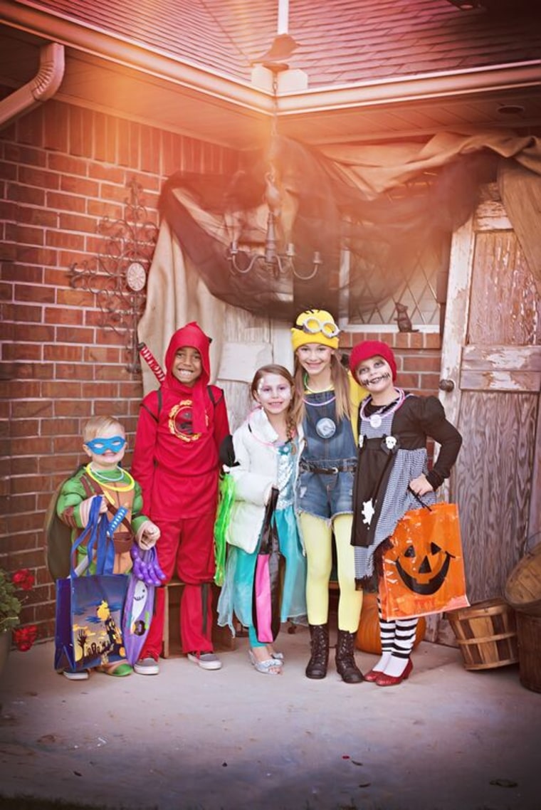 Taking a group shot of your kids and their trick-or-treating buddies can be a great way to get kids to hold still for a photo on Halloween night.