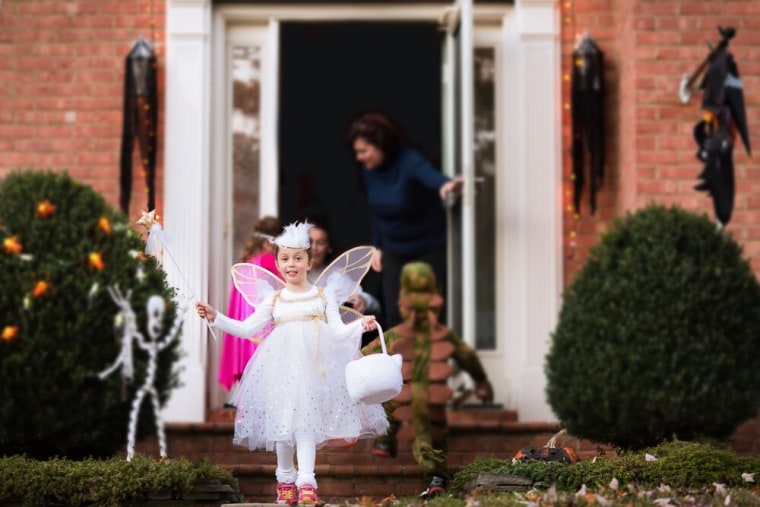 When kids' backs are to you at doorsteps, set up your shot. Then you are ready to capture their expression as they turn around with their treat.