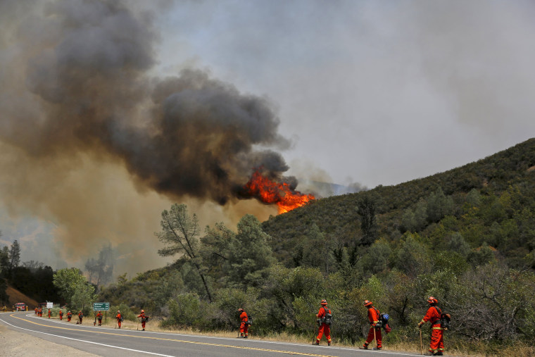 Image: Inmate Firefighters stand along Highway 20 during the Rocky Fire near Lower Lake, California
