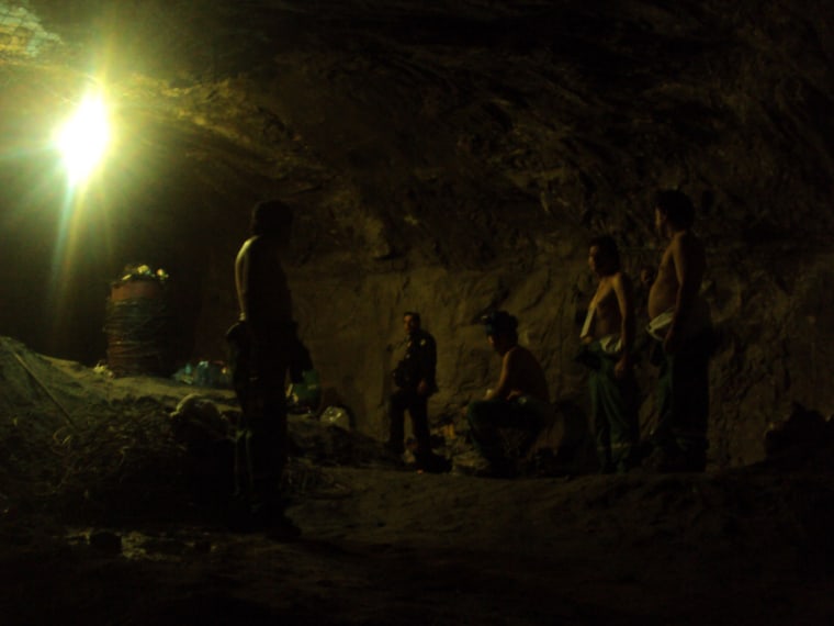 Image: Chilean trapped miners gather inside the San Jose mine as the rescue operation starts in Copiapo