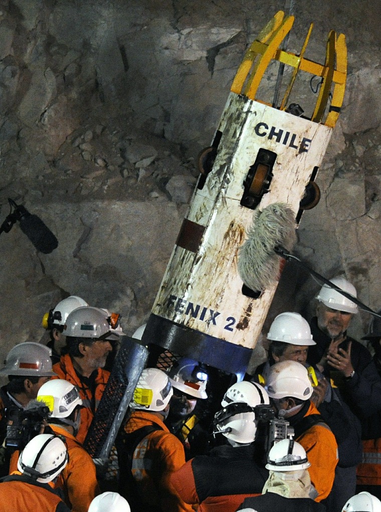 Image: Chilean miner Juan Aguilar (C) talks to