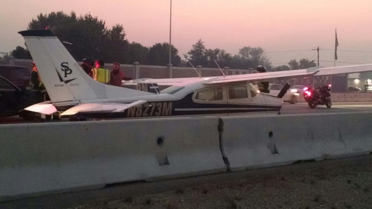 Image: A small aircraft lands on interstate