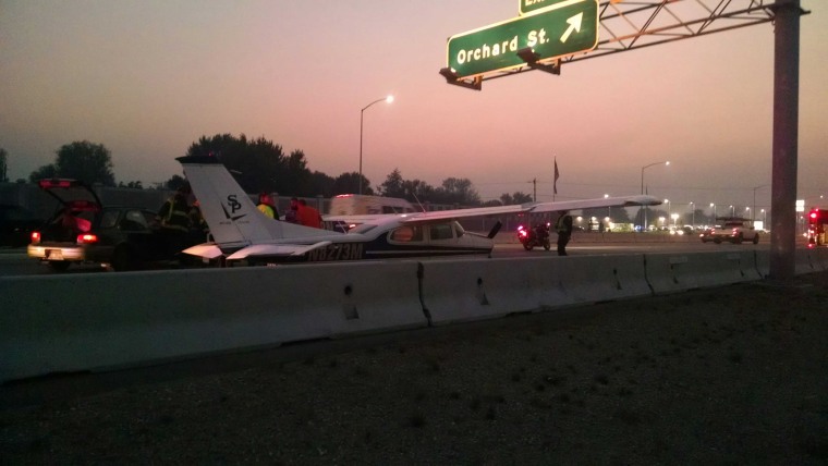 Image: A small aircraft lands on interstate