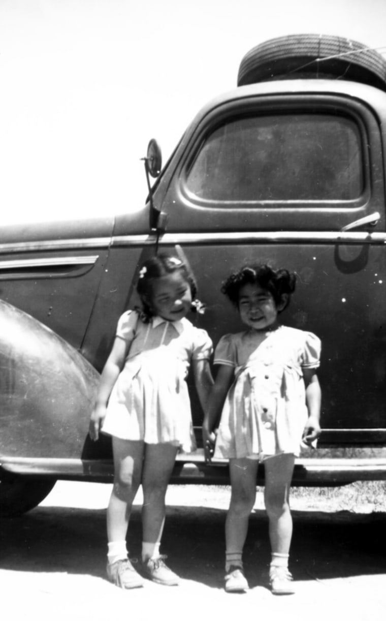 Cousins Jane Kitamoto (left) and Natalie Hayashida (right) preparing to leave Minidoka concentration camp (Idaho).