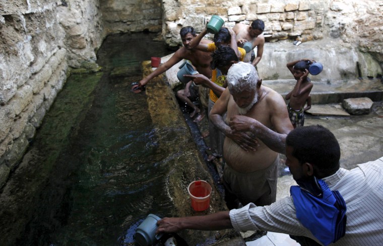 Image: People bathe with spring water