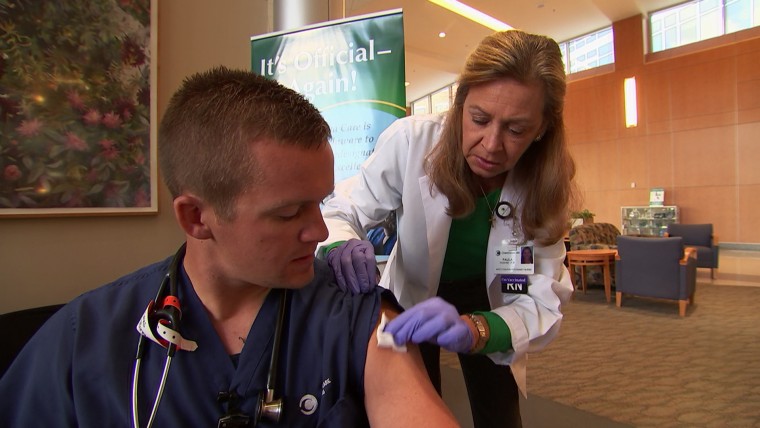 Staff at Christiana Hospital System in Delaware vaccinate one another against flu