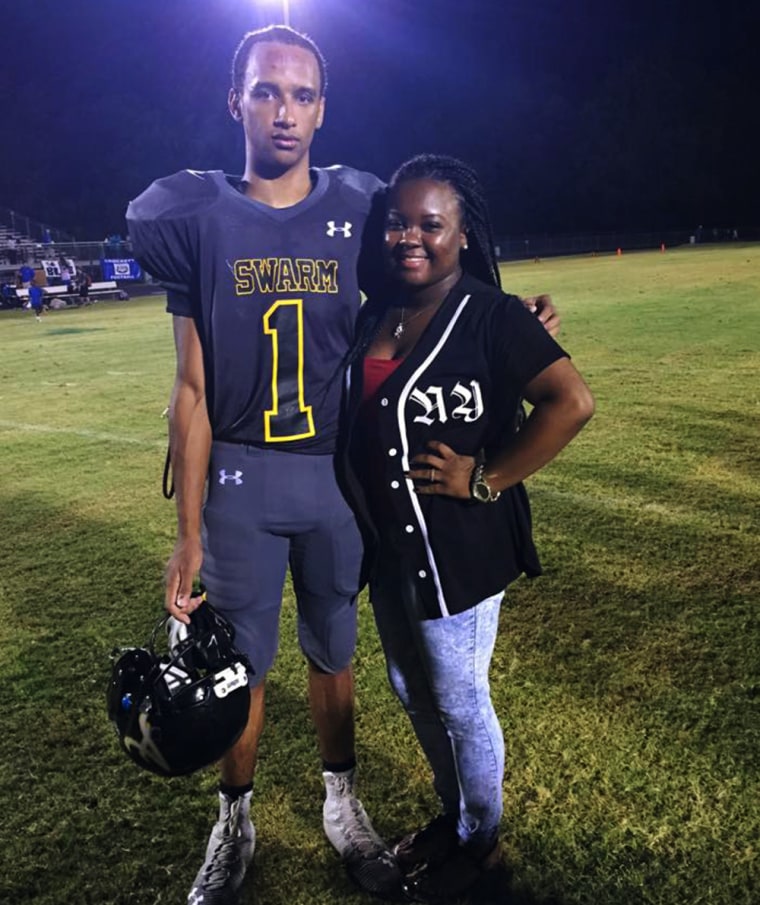 Cam'ron Matthews poses on the field with his sister Paige Matthews.