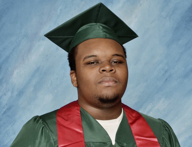 Image: Michael Brown poses for a photo in his cap and gown taken in March 2014