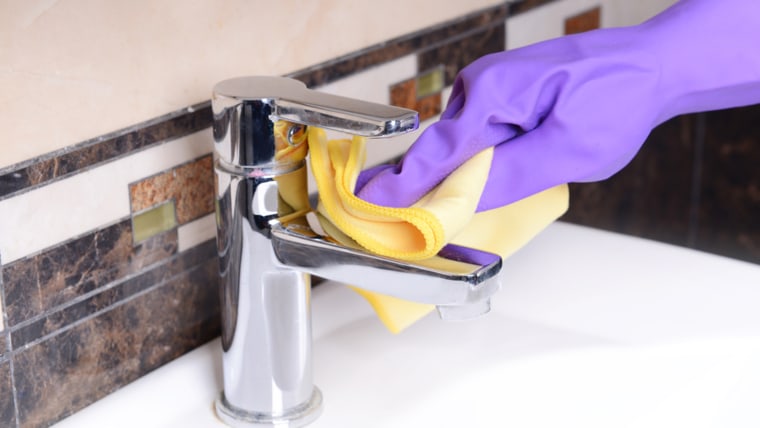 Cleaning bathroom sink close-up